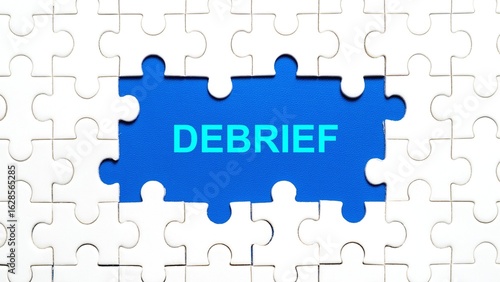 Conceptual image of a missing puzzle piece showing the text 'DEBRIEF' on a blue background.