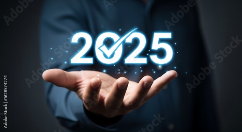 Wallpaper Mural Man holding glowing 2025 with checkmark over dark background new year future Torontodigital.ca