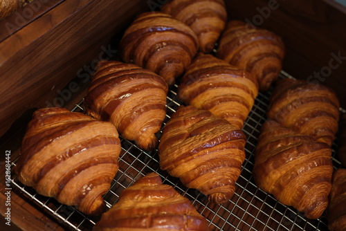Fotografie Close-up Croissants Stacked on Wire Rack Cooling Rack