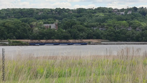 grass swaying in breezy wind breeze croton hudson river rail bridge view mountains westchester new york water usa america train viaduct
