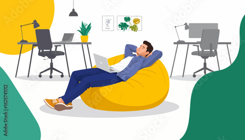 Young man relaxing in a yellow beanbag chair with a laptop, enjoying a break in a modern co-working office environment.