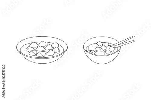 Cubes in broth with chopsticks bowl food