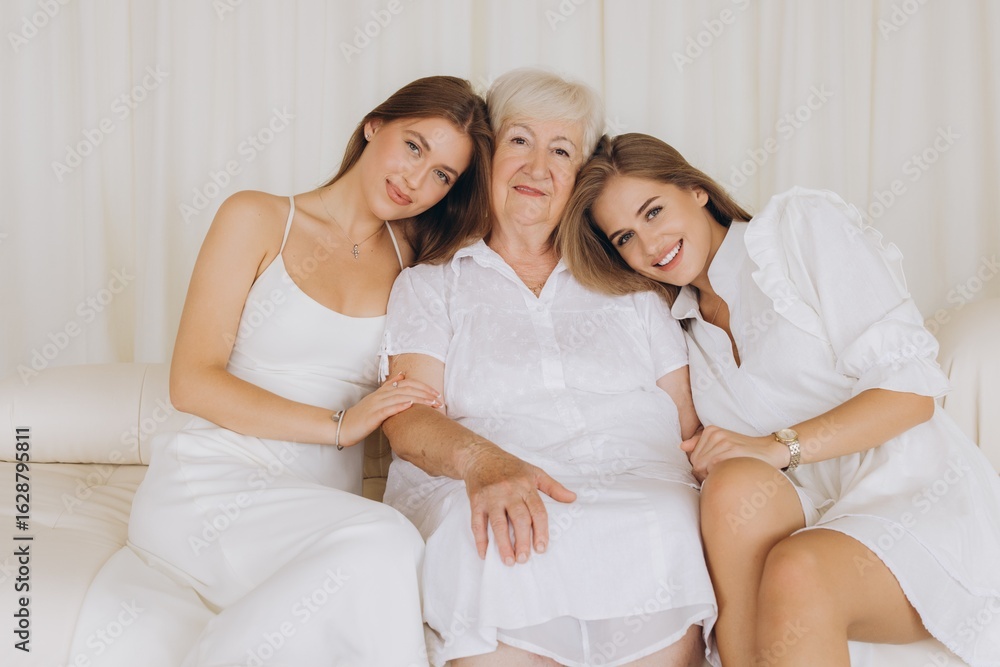 Granddaughters showing love to grandmother sitting on sofa Granddaughters showing love to grandmother sitting on sofa