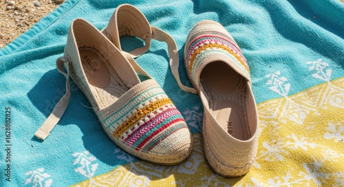 Summer shoes on a beach towel