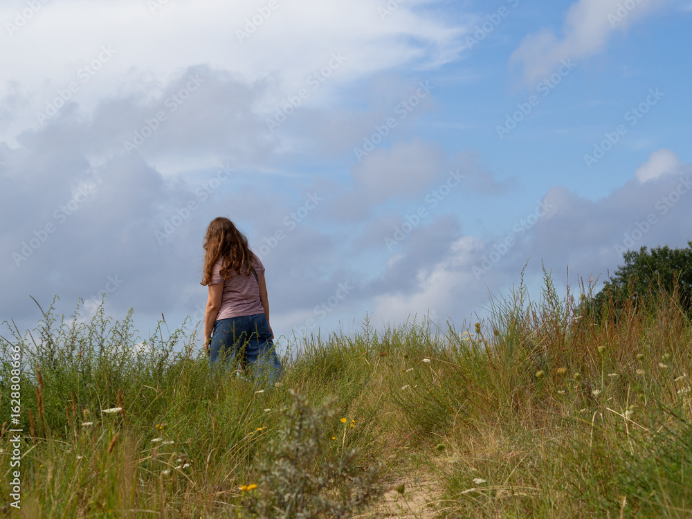 Woman walking alone in coastal dunes for stress relief and mental clarity – perfect for wellness and self-care visuals, burnout therapy, family outdoor vacation Woman walking alone in coastal dunes for stress relief and mental clarity – perfect for wellness and self-care visuals, burnout therapy, family outdoor vacation