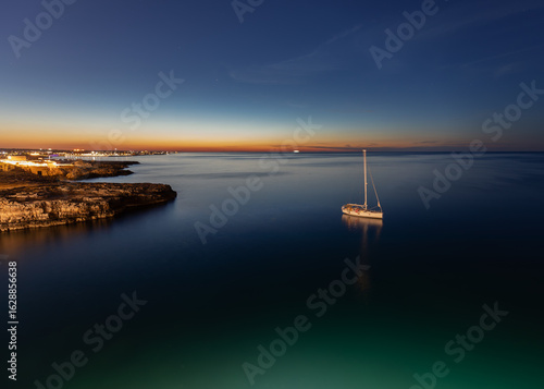 Sailboat anchored at sunset...