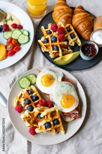 Wallpaper Mural Delicious Breakfast Platter with Waffles, Eggs, Croissants, and Fresh Berries on a Linen Tablecloth, Perfect for a Weekend Brunch or a Special Morning Treat Torontodigital.ca