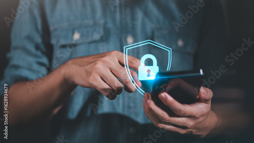 Wallpaper Mural A person using smartphone with glowing padlock icon, representing mobile cybersecurity, encrypted access, digital privacy protection, and secure data communication in smart technology environments. Torontodigital.ca