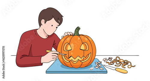 Young man with a focused expression skillfully carves a spooky face into a pumpkin for halloween preparation at the table