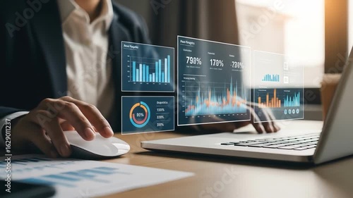 Hands work at a laptop showing futuristic data graphs A person in a suit analyzes financial insights for strategic business growth and investment decisions