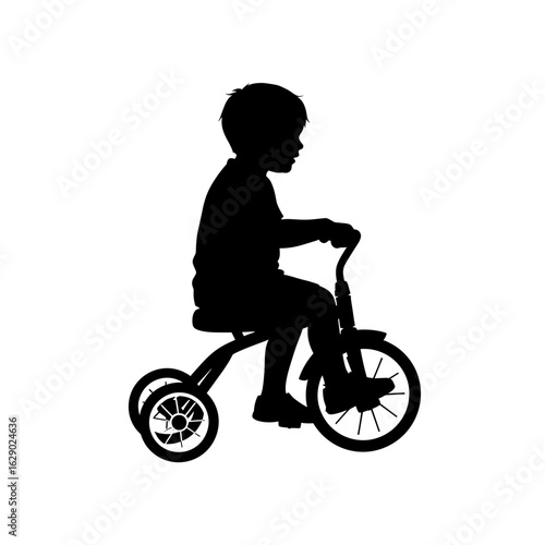 Silhouette of a young child riding a tricycle with two wheels in the rear and one in the front