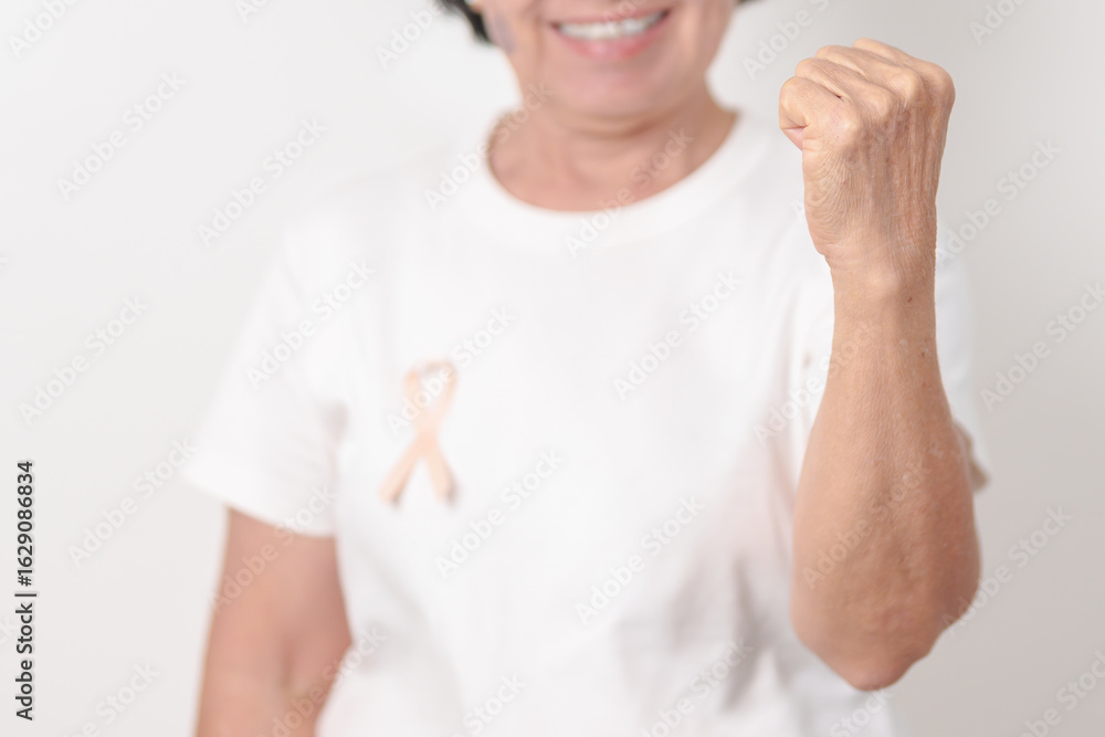 Elderly woman with Peach Ribbon for September Uterine Cancer Awareness month, Endometrial Cancer, Gynecologic, Uterus and Ovaries, Endometriosis, June Vaginal cancer and World cancer day concept Elderly woman with Peach Ribbon for September Uterine Cancer Awareness month, Endometrial Cancer, Gynecologic, Uterus and Ovaries, Endometriosis, June Vaginal cancer and World cancer day concept