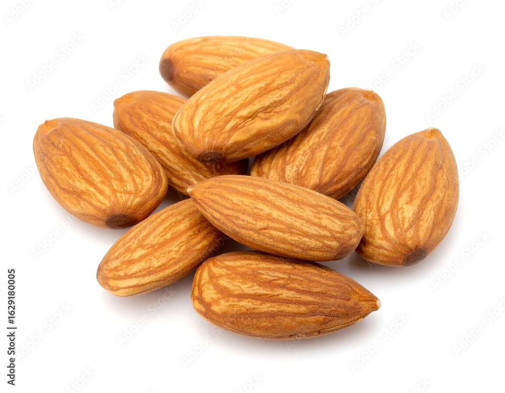 A small pile of light brown almonds, shelled and arranged on a white background A small pile of light brown almonds, shelled and arranged on a white background