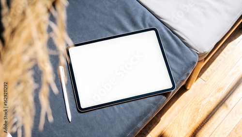 Blank Tablet And Stylus On Gray Cushioned Sofa Surface	