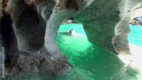 Within the Marble Caves of Patagonia, turquoise water reflects off sculpted formations. Sunlight dances across the mineral-rich walls in Lago General Carrera, creating a surreal vista.