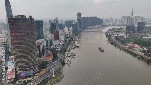 Saigon River Skyline, Ho Chi Minh City – 4K Morning Drone View of Bitexco Tower, Landmark 81, Thu Thiem, Waterfront, and Urban Development in Vietnam