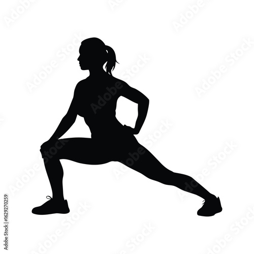 Silhouette of a woman stretching her leg and warming up before exercise