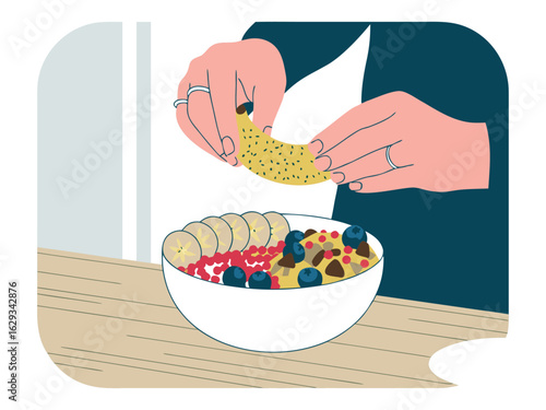 Person adding banana slices to a healthy bowl of oatmeal with berries breakfast food