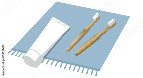 Dental care items on blue towel with two toothbrushes and toothpaste  