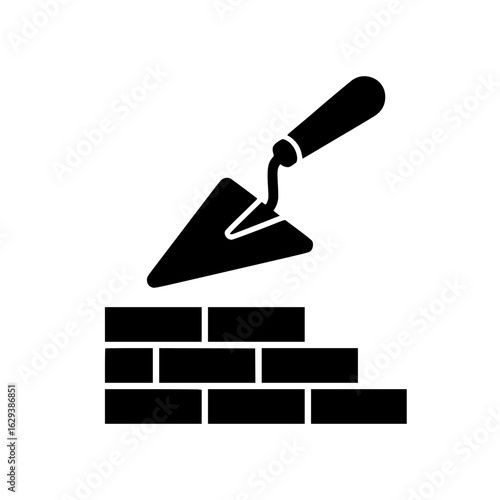 Black silhouette of a brick wall under construction with a trowel tool isolated on white background