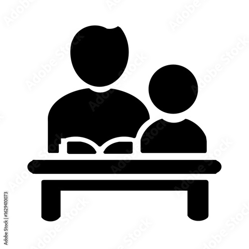 Black silhouette icon of adult and child sitting at table with open book representing learning and tutoring