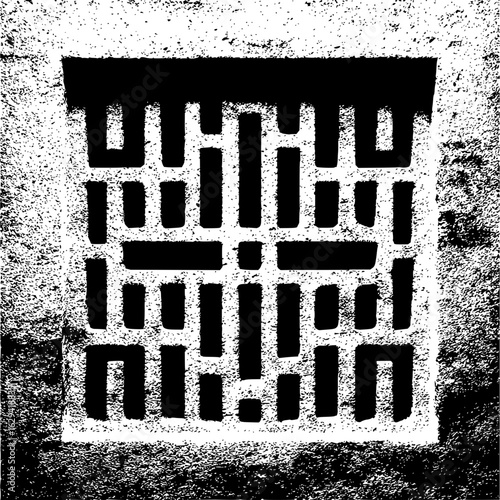 Close up of a square vent with a grid pattern set into a textured wall in black and white monochrome style