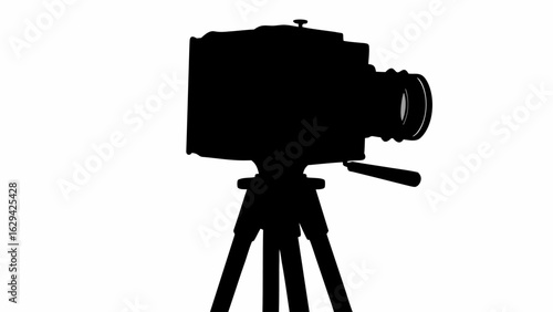Silhouette of a large format camera mounted on a tripod, capturing vintage photographic equipment