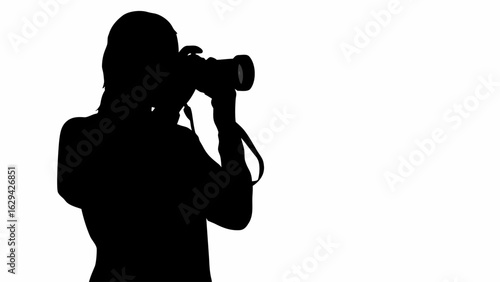 Silhouette of a photographer holding a camera with a strap against a white background image view