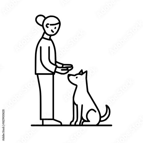 A woman is training her dog with a treat in her hand and the dog is patiently waiting for the treat to eat it