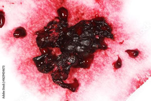 A piece of fruit with a lot of blood on it