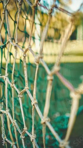 A close up view of the netting commonly used in sports facilities as a barrier or safety mesh.