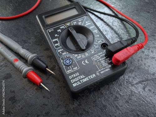Quadro su tela A hand holding a digital multimeter for electrical work