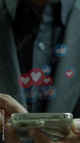 Businessman using a social media marketing concept on mobile phone with notification icons of like and love above smartphone screen. Technology communication network online concept.