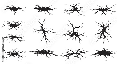 Collection of various black cracked ground textures and surface damage elements isolated on white background