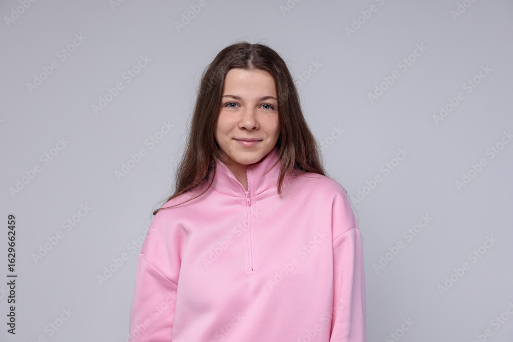 Fototapeta premium Portrait of teenage girl on light grey background