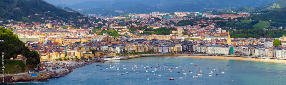 Fototapeta premium Aerial panoramic view of the city and the famous La Concha beach with promenade in San Sebastian, Spain