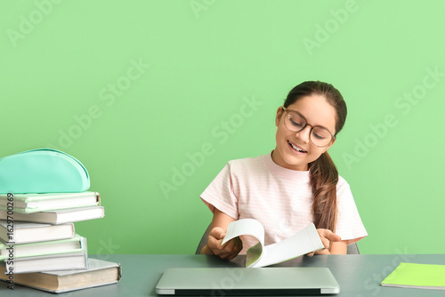 Little girl doing lessons a...