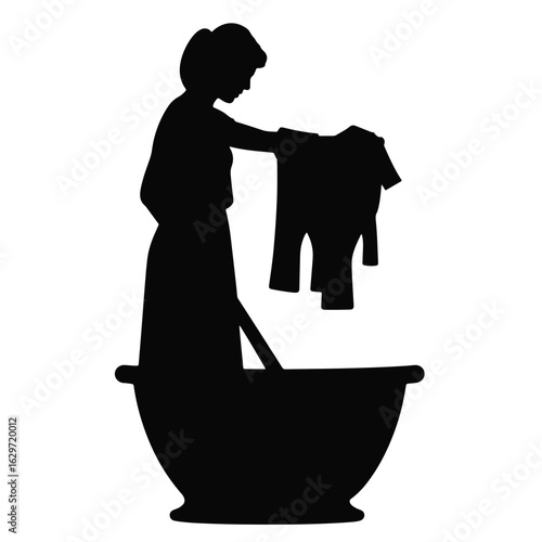 Silhouette of woman doing laundry in basin, household chores