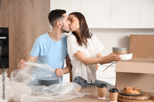 Young couple kissing while ...
