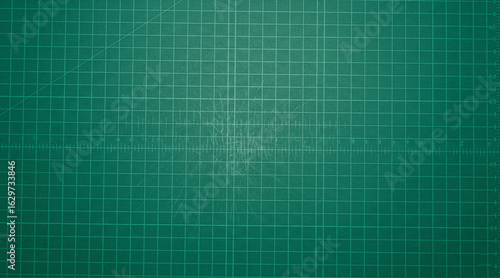 Top-down view of a textured green cutting mat with a precise grid pattern, serving as a clean and useful background for design, crafts, and DIY themes.

