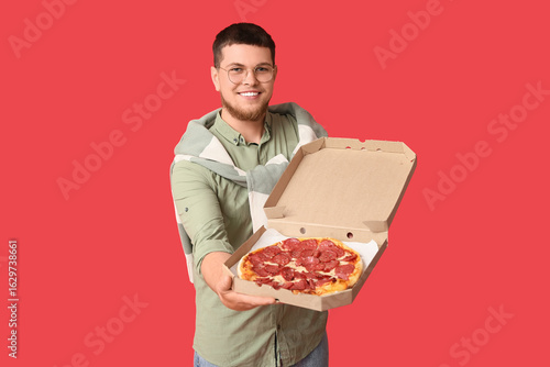 Young man holding cardboard...
