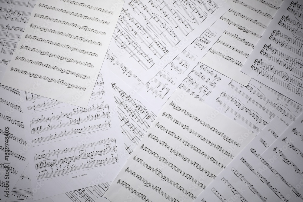Fototapeta premium Sheets with musical notes as background, top view
