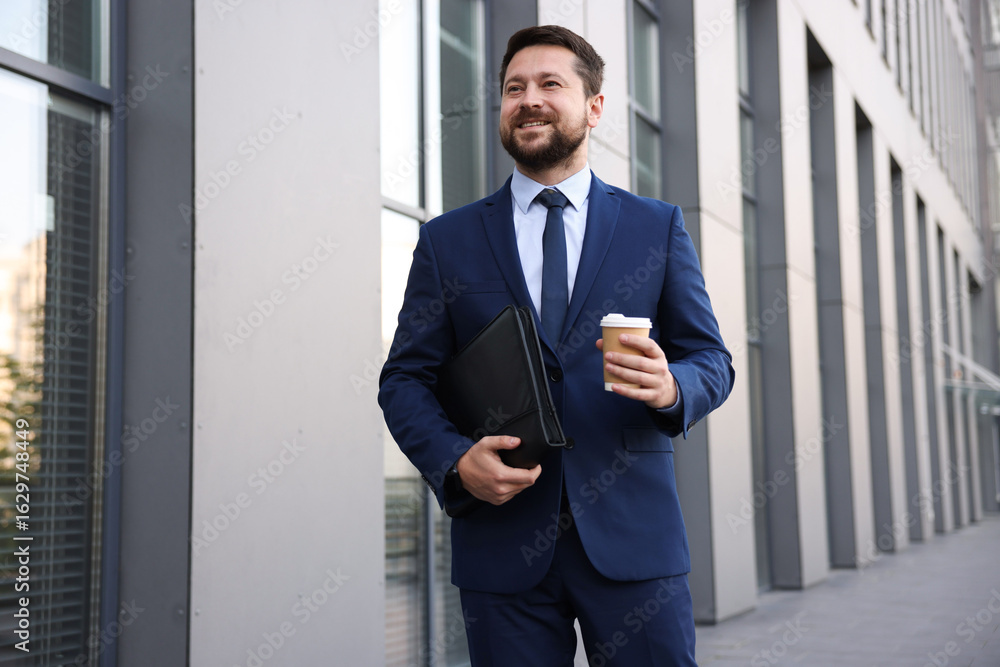 Fototapeta premium Successful businessman with coffee near office building