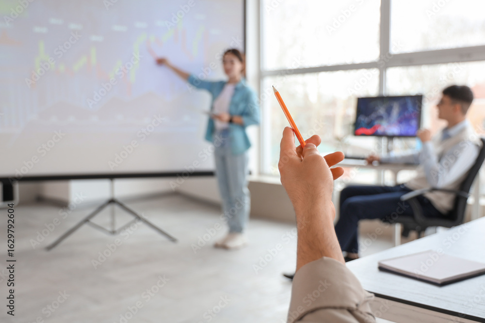 Fototapeta premium Hand of male trader with pencil during presentation in office, closeup