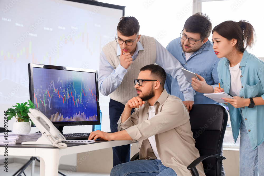Fototapeta premium Team of traders working at table in office