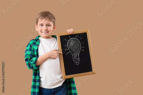 Cute boy pointing at chalkb...