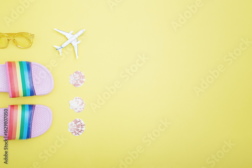 Wallpaper Mural Rainbow slippers, toy airplane, seashells and sunglasses on a yellow background. Summer holiday, travel and vacation concept. Flat lay, copy space Torontodigital.ca