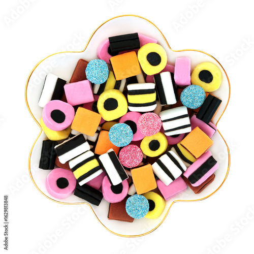 Foto Licorice allsorts in scallop shaped bowl on white background