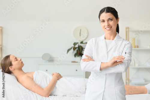 Female beautician against c...