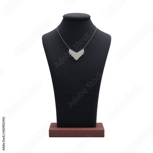 Elegant silver necklace displayed on a black velvet bust against a solid white background, perfect for showcasing exquisite jewelry and accessories.